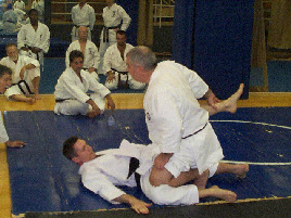 Kyoshi McCarthy applying knee pressure after take down.