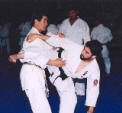 Sensei Ishikawa demonstrating takedown techniques in fighting.