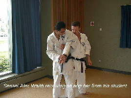 Sensei Alex Waith receiving an armbar from his student.